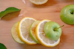 Apple and Lemon on Wood background photo