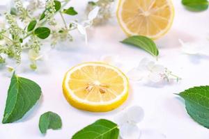 Creative layout made of lemon and leaves. Flat lay. Food concept. Lemon on white background photo