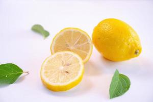 Creative layout made of lemon and leaves. Flat lay. Food concept. Lemon on white background photo