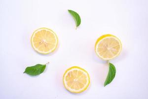 Creative layout made of lemon and leaves. Flat lay. Food concept. Lemon on white background photo