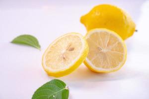 Creative layout made of lemon and leaves. Flat lay. Food concept. Lemon on white background photo