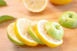 Apple And Lemon slice with Leaf on Wood background photo