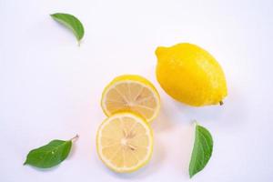 Creative layout made of lemon and leaves. Flat lay. Food concept. Lemon on white background photo