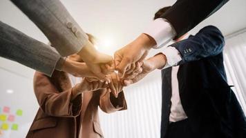 Close up on hands of business people join together their hands together on unity concept photo