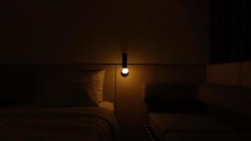 dark hotel room with yellow bulb light photo