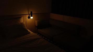 dark hotel room with yellow bulb light photo