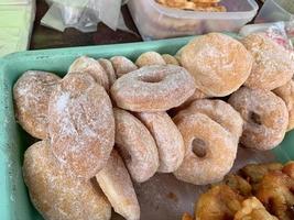 Indonesian traditional market snacks, powdered sugar donuts photo