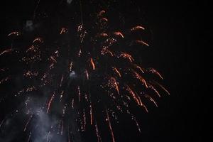 fireworks and salute lights on the background of the black sky. Christmas fireworks in the night sky. New Year celebration photo