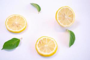Creative layout made of lemon and leaves. Flat lay. Food concept. Lemon on white background photo