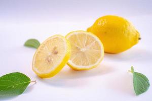 Creative layout made of lemon and leaves. Flat lay. Food concept. Lemon on white background photo