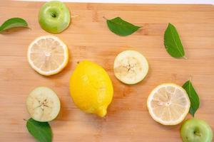 Apple And Lemon slice with Leaf on Wood background photo