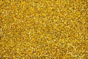 Gold glittering stars dust and bokeh background. Abstract christmas glow light texture. photo