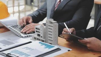 Discussion with a real estate agent, House model with agent and customer discussing for the contract to buy, get insurance or loan real estate or property. video