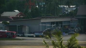 PHUKET, THAILAND   NOVEMBER 28, 2016 - Eurocopter EC 130T2 helicopter attempting to land at Phuket airport, Thailand video