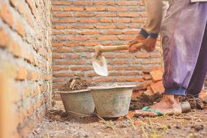 construction worker hoeing to level the house building photo