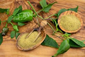 spicy pepper on olive wood photo