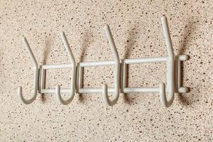 White Clothes hanger on a wall background. photo