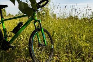 Cycling, mountain bike wheel on green grass. photo