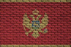 Montenegro flag is painted onto an old brick wall photo