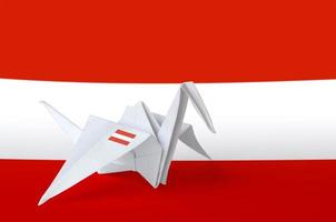 Austria flag depicted on paper origami crane wing. Handmade arts concept photo