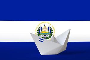 El Salvador flag depicted on paper origami ship closeup. Handmade arts concept photo