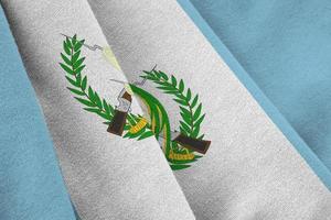 Guatemala flag with big folds waving close up under the studio light indoors. The official symbols and colors in banner photo