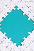 Framing in the form of a rhombus, made of a white jigsaw puzzle around the blue space photo