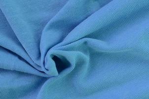 The texture of the fabric in blue color. Material for making shirts and blouses photo