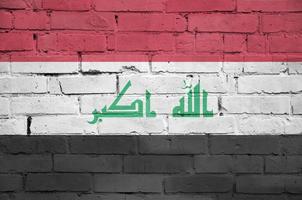 Iraq flag is painted onto an old brick wall photo