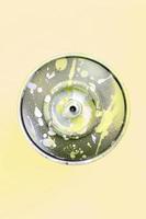 Single used spray can for graffiti drawing lies on a pastel colored backgroung. Street art painting concept. Minimal flat lay. Top view photo
