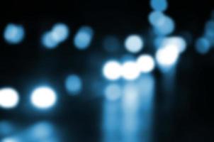Blurred night scene of traffic on the roadway. Defocused image of cars traveling with luminous headlights. Bokeh Art photo