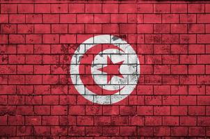 Tunisia flag is painted onto an old brick wall photo