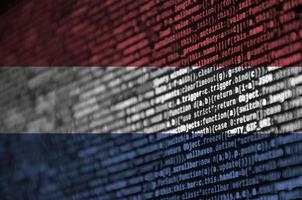 Netherlands flag  is depicted on the screen with the program code. The concept of modern technology and site development photo