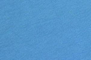 The texture of the fabric in blue color. Material for making shirts and blouses photo