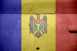 Moldova flag depicted on side part of military armored helicopter closeup. Army forces aircraft conceptual background photo