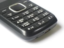 Teléfono móvil negro con pulsador y disposición en ruso e inglés foto