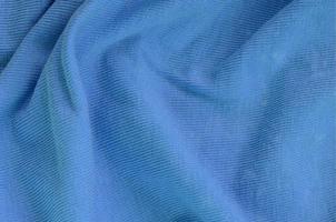 The texture of the fabric in blue color. Material for making shirts and blouses photo