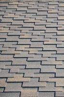 Modern roofing and decoration of chimneys. Flexible bitumen or slate shingles photo