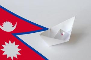 Nepal flag depicted on paper origami ship closeup. Handmade arts concept photo