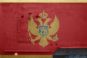 Montenegro flag depicted on side part of military armored truck closeup. Army forces conceptual background photo