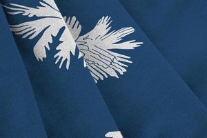 South Carolina US state flag with big folds waving close up under the studio light indoors. The official symbols and colors in banner photo