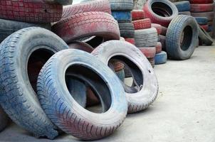 A picture of many old used tires left on a waste dump photo