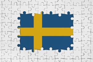 Sweden flag in frame of white puzzle pieces with missing central part photo