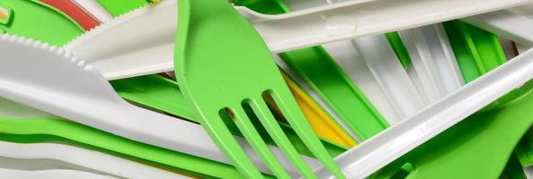 Pile of bright yellow, green and white used plastic kitchenware appliances photo