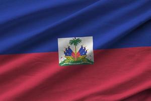 Haiti flag with big folds waving close up under the studio light indoors. The official symbols and colors in banner photo