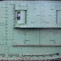 Texture of tank side wall, made of metal and reinforced with a multitude of bolts and rivets photo