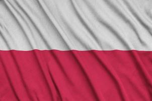 Poland flag  is depicted on a sports cloth fabric with many folds. Sport team banner photo