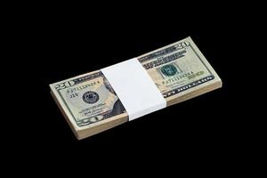 Bundle of US dollar bills isolated on black. Pack of american money with high resolution on perfect black background photo