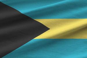 Bahamas flag with big folds waving close up under the studio light indoors. The official symbols and colors in banner photo