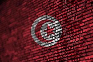 Tunisia flag  is depicted on the screen with the program code. The concept of modern technology and site development photo